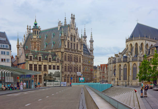 Leuven, Belgium - July 20, 2014: View of medieval Town Hall and aps of St Peter’s church on the right