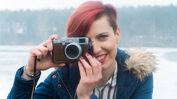 istock Young woman with camera in nature 641280986