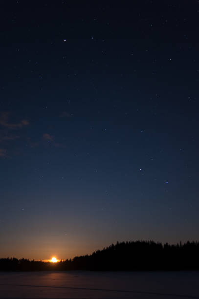 istock Moon rising over winter landscape at night 641281622