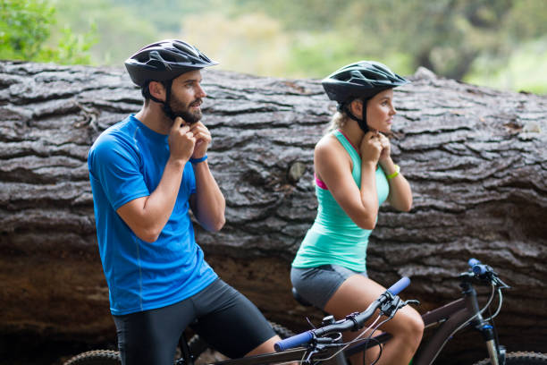 istock Athletic couple wearing bicycle helmet in forest 641283610