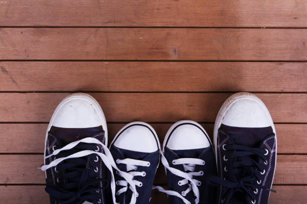 istock Old canvas shoes on a wooden floor 641284958