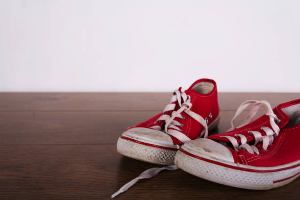istock Old canvas shoes on a wooden floor 641285002