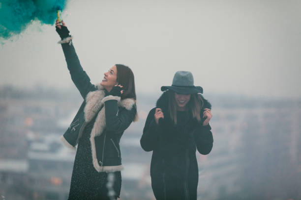 istock Happy Young Women Having Fun With smoke bomb 641286942