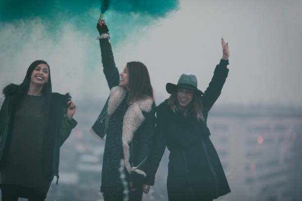 istock Happy Young Women Having Fun With smoke bomb 641287148