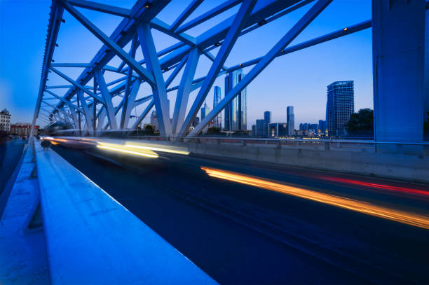 istock bridge girder highway car light trails city night landscape 641287748