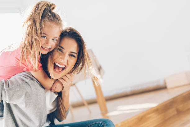 Mother and daughther happy together Young woman and small girl having a great time together 4 year old girl stock pictures, royalty-free photos & images