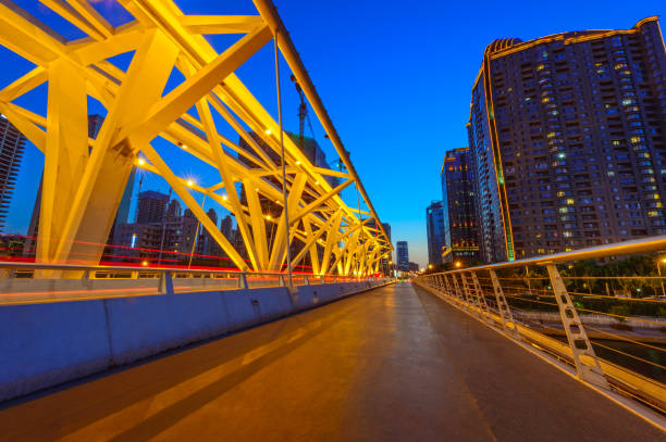 bridge girder highway car light trails city night landscape