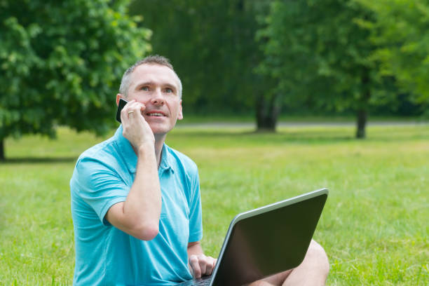 istock Man working on his laptop in the park 641290290