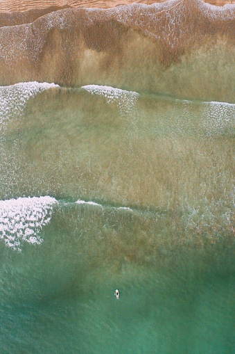 Aerial view of person on surfboard in sea in Sri Lanka