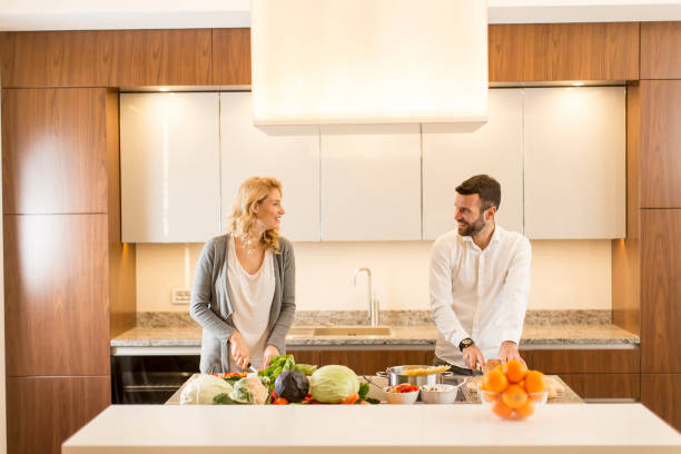 istock Young loving couple preparing tasty meal 641294292