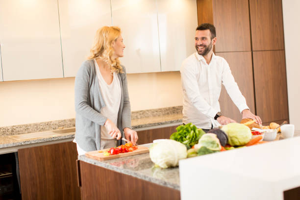 istock Young loving couple preparing tasty meal 641294356