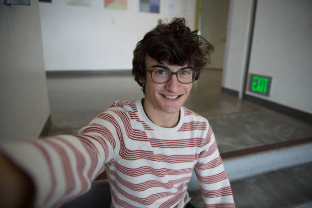 Teen Boy With Glasses Taking Selfie Smiling