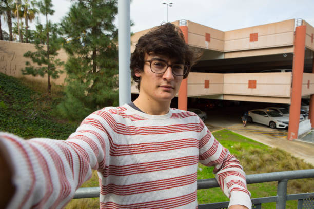 istock Teen Boy With Glasses Taking Selfie Smiling 641299366
