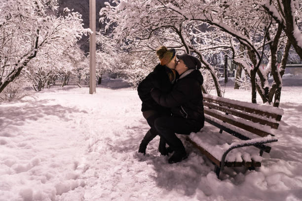 istock Romantic couple kissing on a bench 641299538