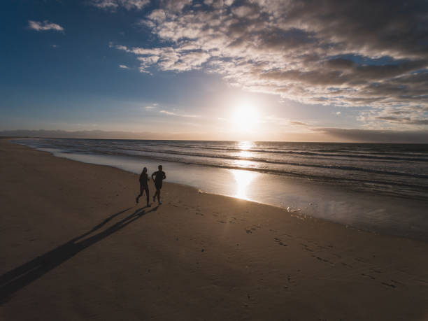 istock People running on the beach in morning 641300906