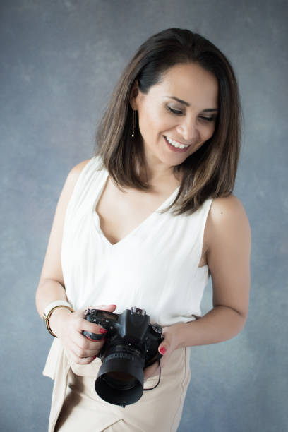 istock Latin american woman with camera 641301636
