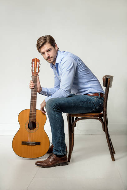 istock portrait of man holding guitar 641303680