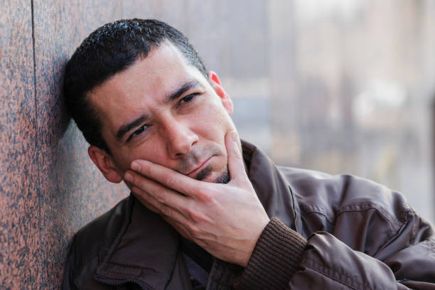 istock Young man with a toothache tooth pain 641304216