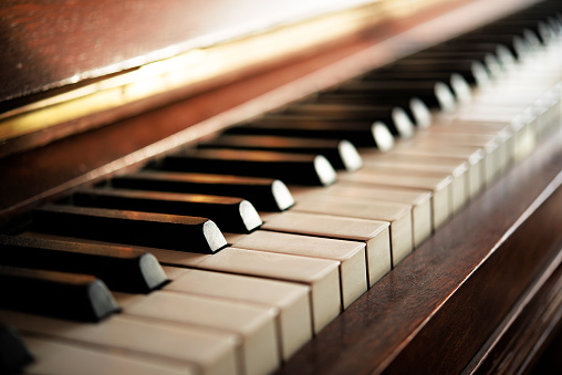 Piano keyboard of an old music instrument, close up