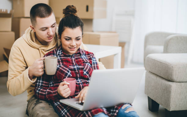 istock Couple on floor next to moving boxes 641310476