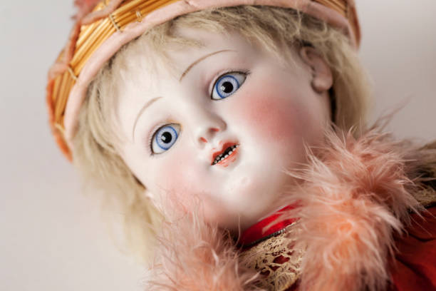istock Antique French doll with blue eyes placed on table. 641310866