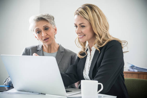 istock Two businesswomen in office using laptop 641311028