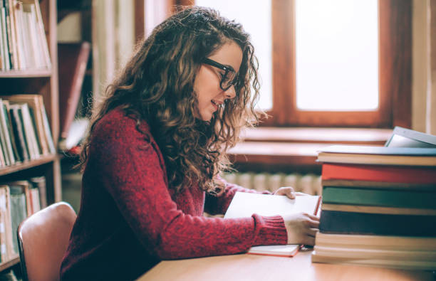 istock Young hipster woman relaxing while reading a book. 641313032