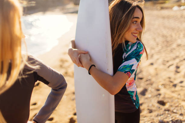 istock Happy surfer girls 641314406