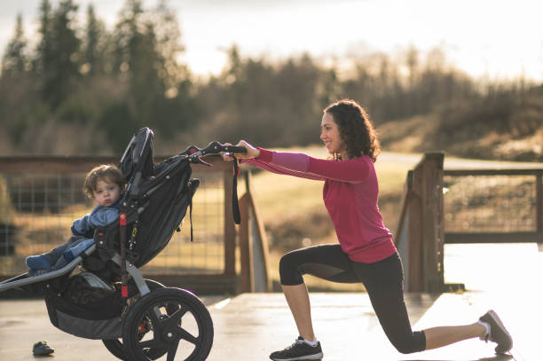 istock Young mom stretching next to child in baby stroller 641315134