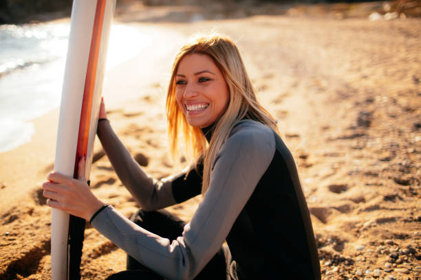 istock Surfer girl having a break from surfing 641315176