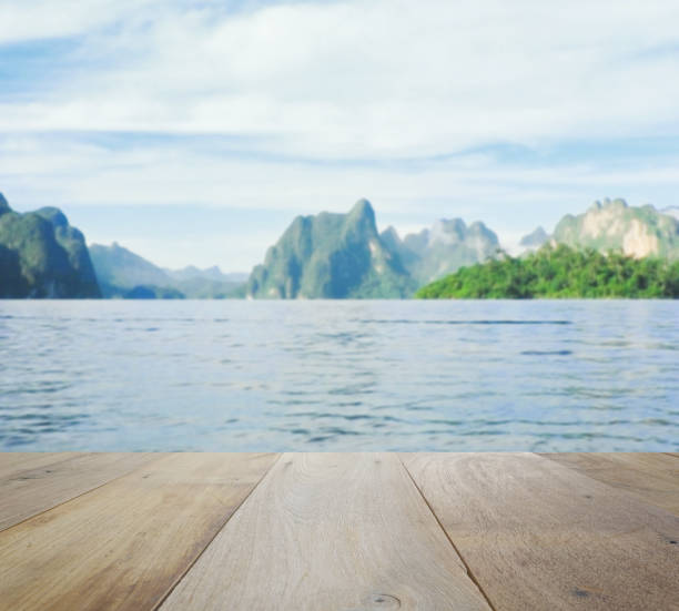 istock wood table top on blurred beautiful landscape with mountain and lake 641316906