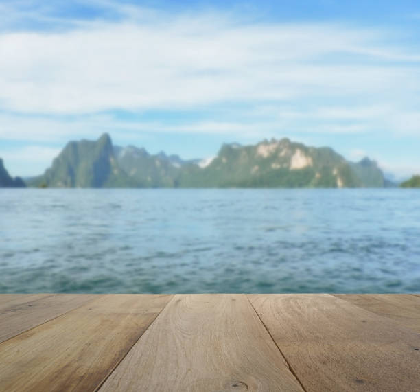 istock wood table top on blurred beautiful landscape with mountain and lake 641316924