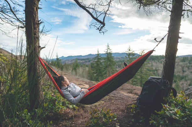 istock Young woman in hammock in forest 641320108