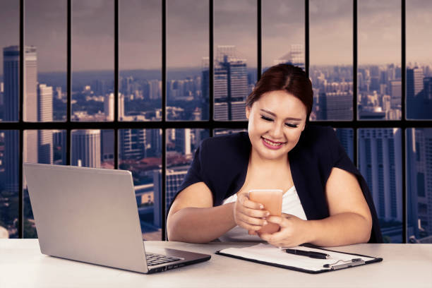 istock Beautiful entrepreneur smiling with cellphone 641322158