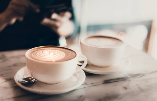 istock man holding smartphone during lunch in coffee shop 641325262