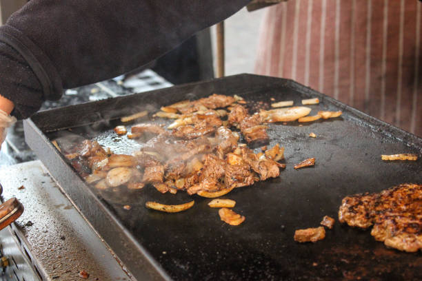 istock Young men cooking teppanyaki steak. 641326882