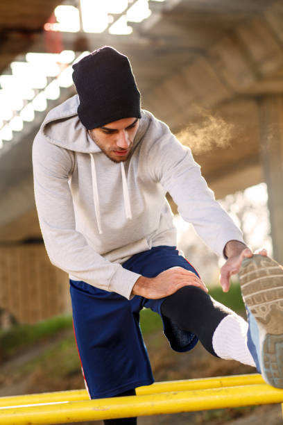istock Young man stretching his muscles under the bridge. 641327766