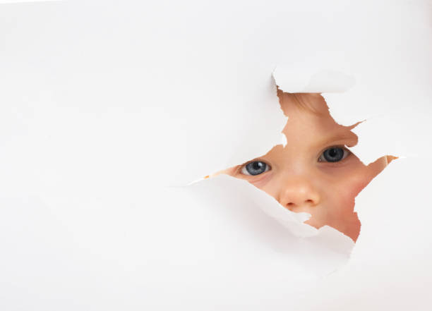 istock Little baby looking out of a hole 641328852
