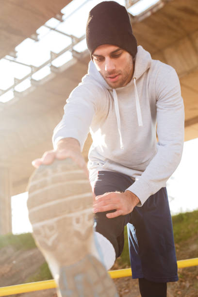istock Young man stretching his muscles under the bridge. 641329294