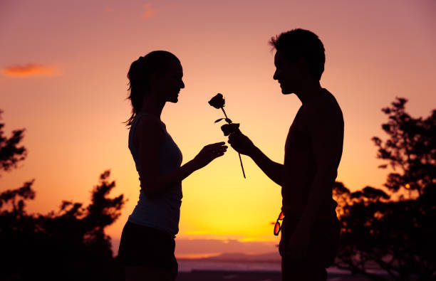 istock Man giving woman a rose. 641330644