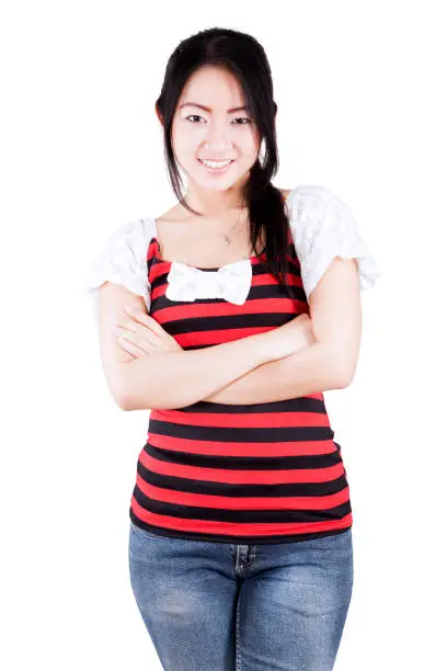 Portrait of confident Asian woman smiling at the camera and standing in the studio, isolated on a white background