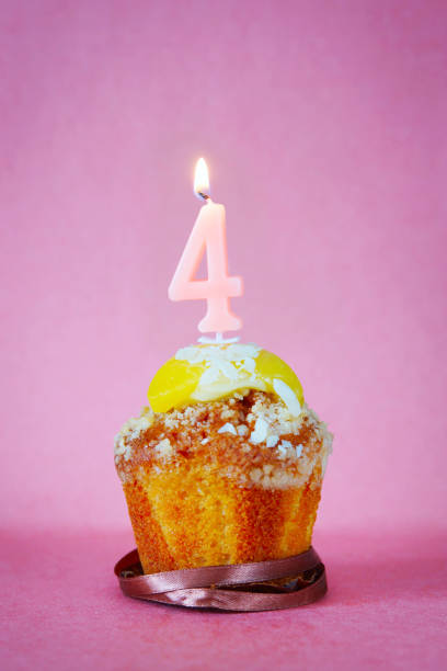 istock Birthday cake with burning candle as number four 641335924