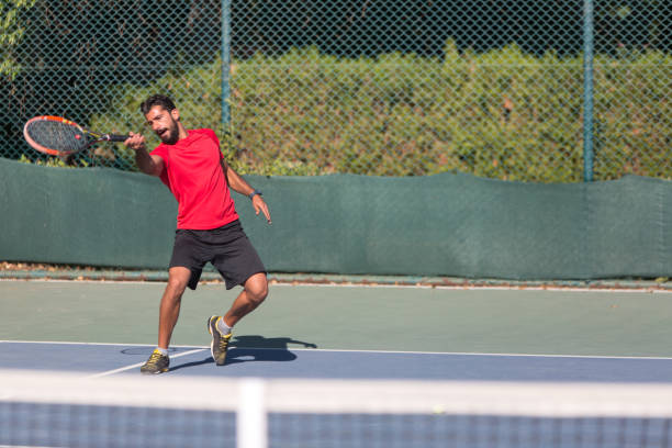 istock Tennis player man hitting ball in a volley. 641336980
