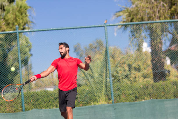 istock Tennis player man hitting ball in a volley. 641337980