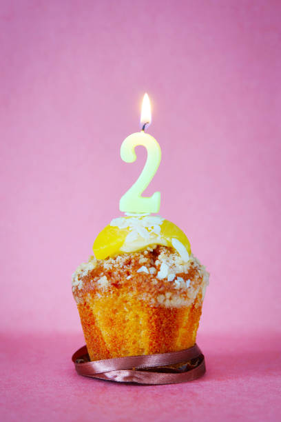 istock Birthday cake with burning candle as number two 641338244
