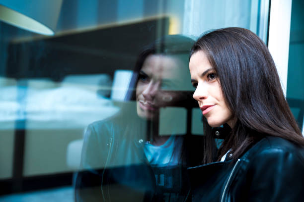 istock Woman sitting by the window 641339362