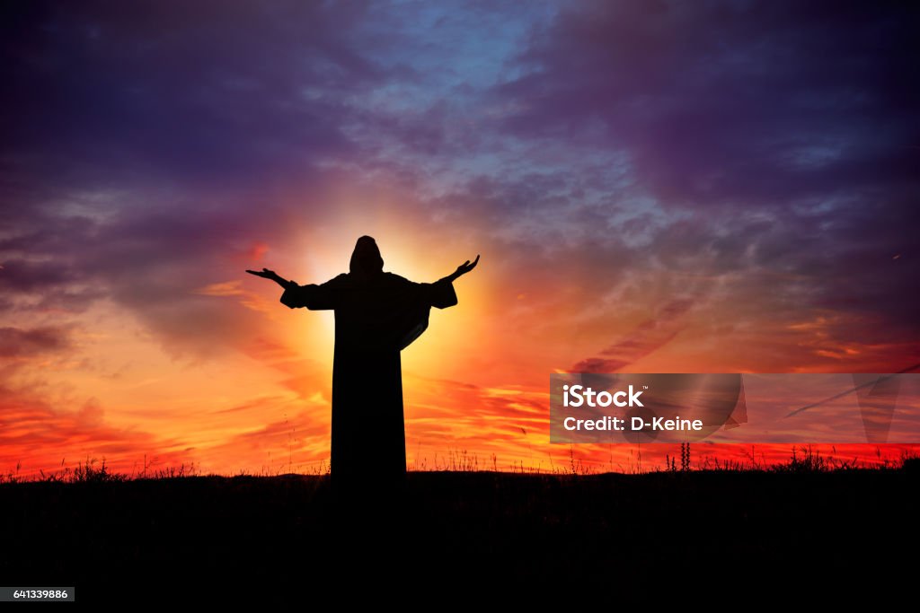 Prayer Man praying at sunset Jesus Christ Stock Photo