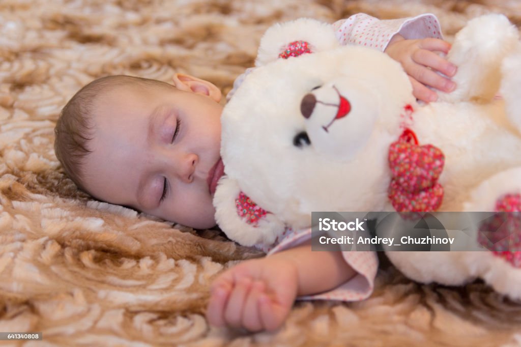Baby sleeping with teddy bear Babies Only Stock Photo