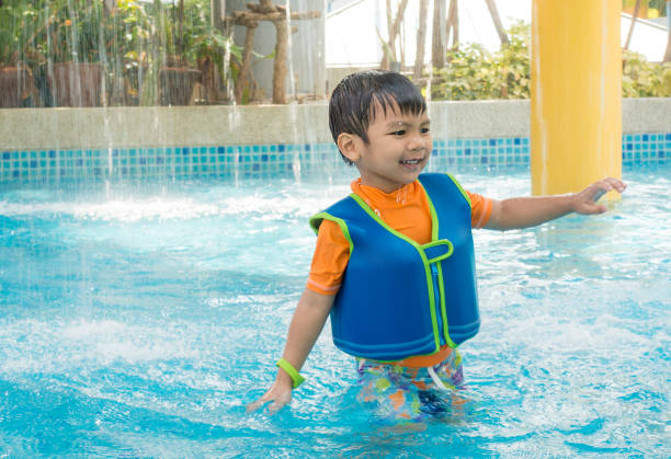 istock Asian boy playing in splashing water park 641345952