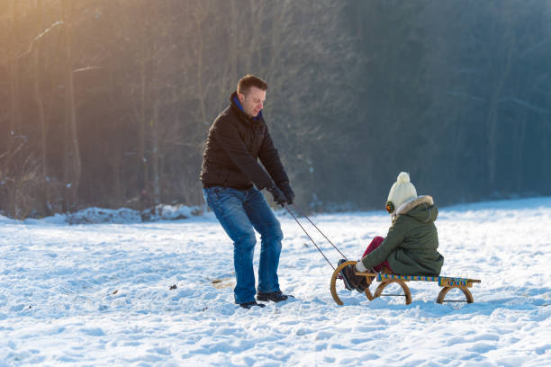 istock Father and daughter on a sled 641348032